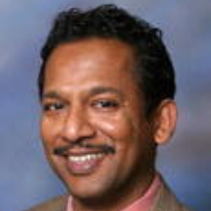 headshot of a man smiling at the camera
